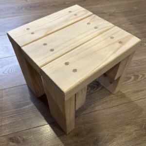 Photo of the small wooden stool taken from slightly above.